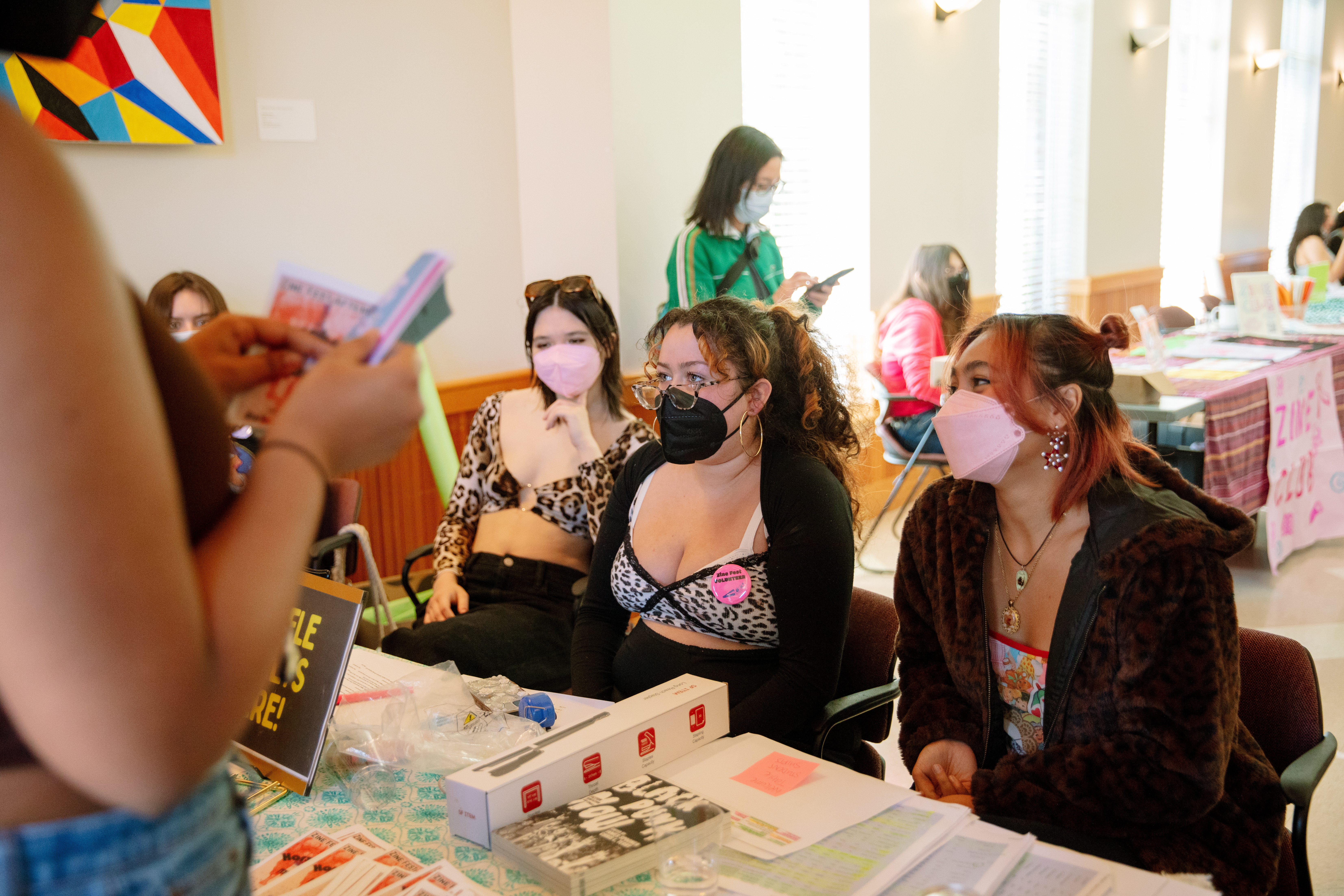 3 student zinesters welcome guests 